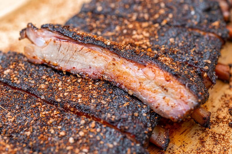 Close-up of smoked BBQ ribs served for an authentic American BBQ catering event