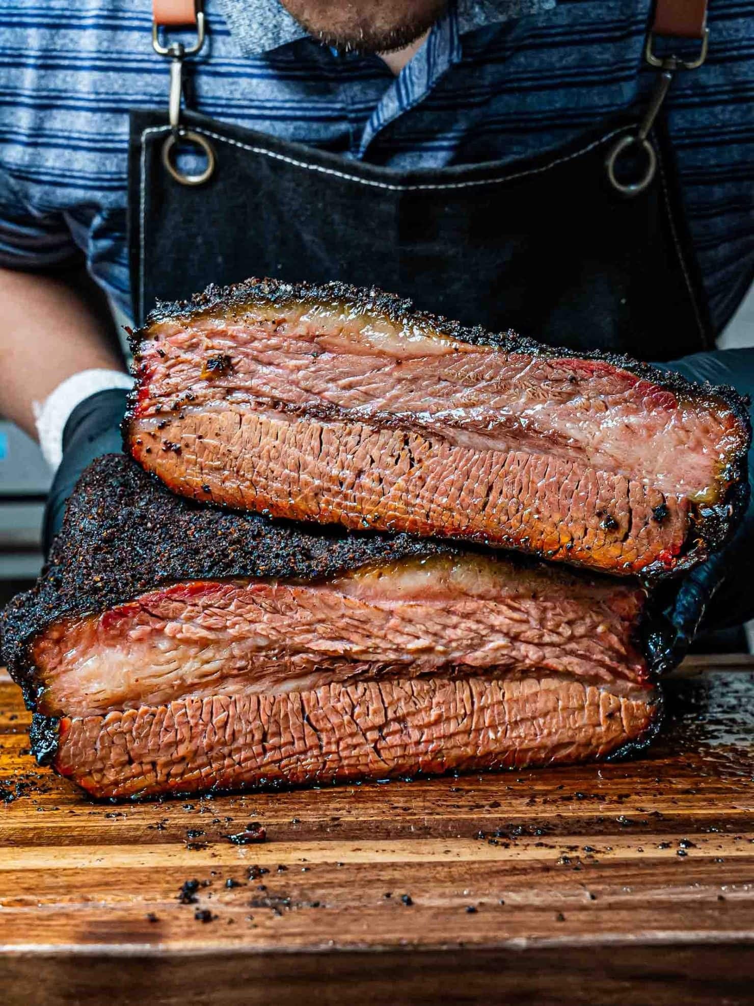 Sliced smoked brisket showing bark, smoke ring and juicy BBQ texture